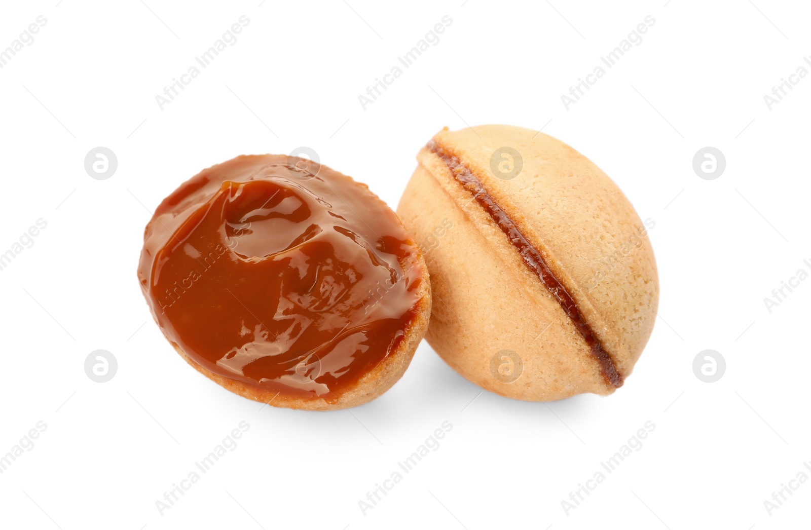 Photo of Delicious nut shaped cookies with boiled condensed milk on white background