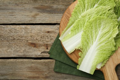 Fresh leaves of Chinese cabbage on wooden table, top view, Space for text