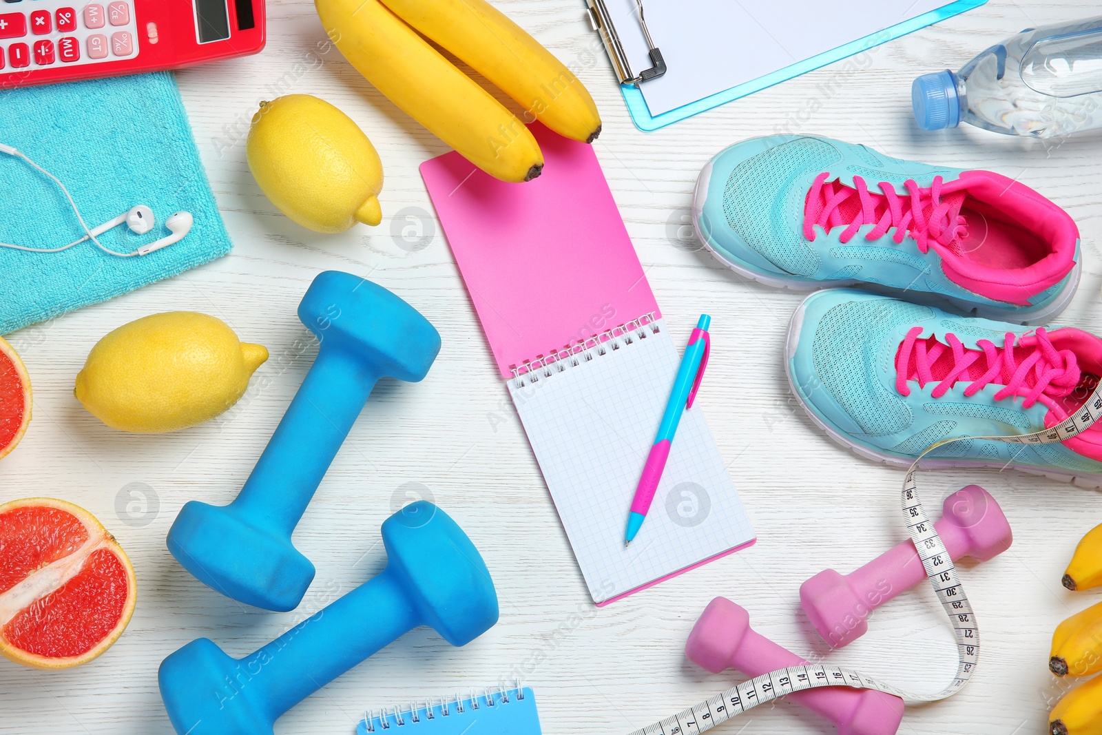 Photo of Flat lay composition with sport items, healthy food and notebook on wooden background. Weight loss concept