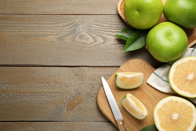 Flat lay composition with sweetie fruits on wooden table, space for text