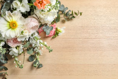 Bouquet of beautiful flowers on wooden table, above view. Space for text