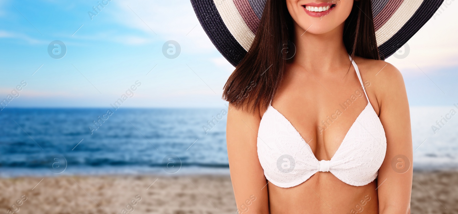 Image of Pretty woman in stylish bikini at beach on sunny day, closeup, space for text. Banner design