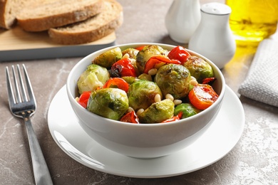 Photo of Bowl of salad with Brussels sprouts on table