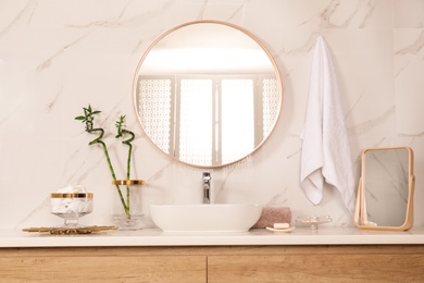 Photo of Stylish bathroom interior with vessel sink and round mirror