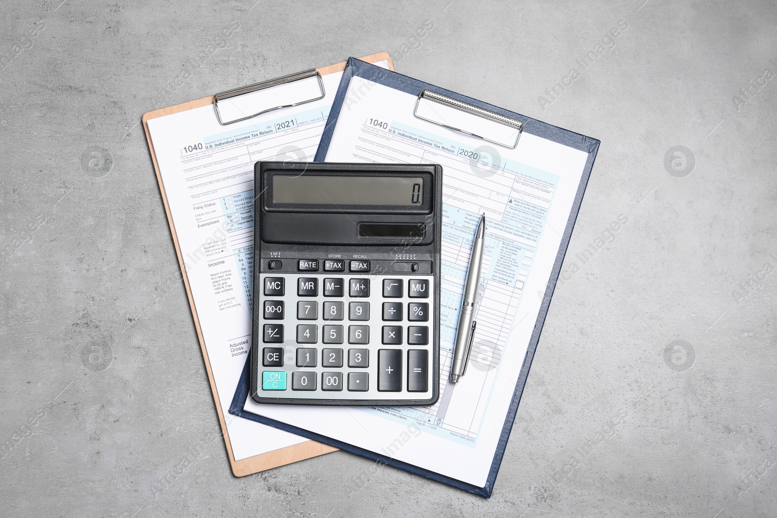 Photo of Calculator, documents and pen on grey table, top view. Tax accounting