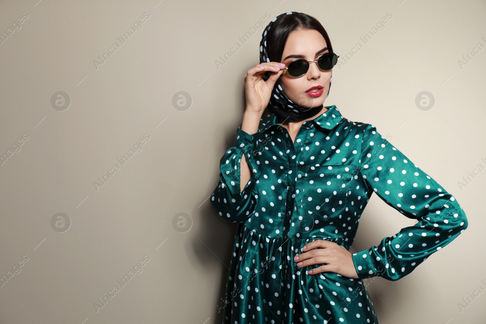 Photo of Beautiful woman in stylish sunglasses on beige background. Space for text