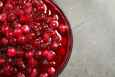 Photo of Fresh cranberry sauce on grey table, closeup