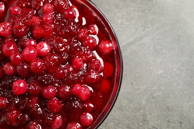 Fresh cranberry sauce on grey table, closeup