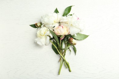 Photo of Beautiful peonies on white wooden table, flat lay