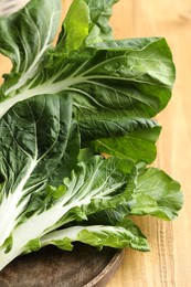 Fresh green pak choy cabbage on wooden table, closeup