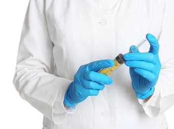 Doctor in medical gloves holding empty syringe on white background