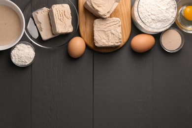 Different types of yeast, eggs and flour on grey wooden table, flat lay. Space for text