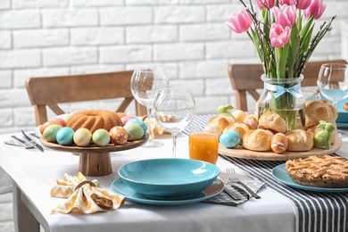 Photo of Festive Easter table setting with traditional meal at home