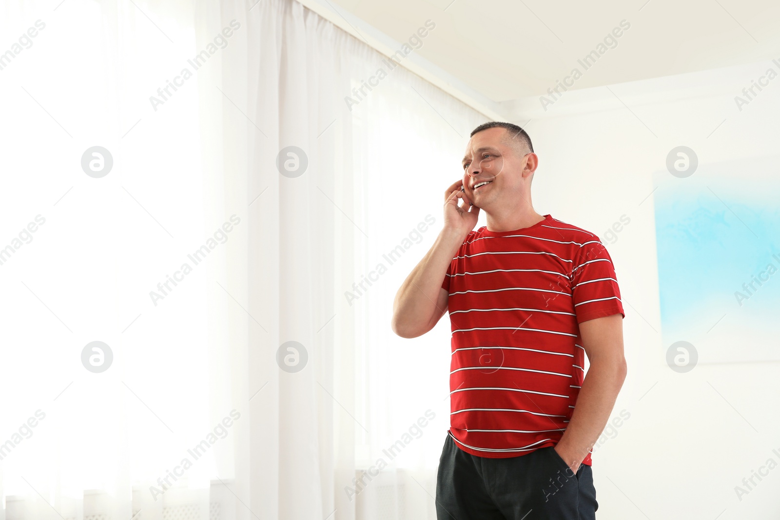 Photo of Portrait of mature man talking on phone indoors. Space for text