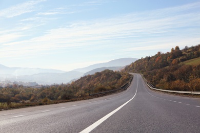 Photo of Landscape with asphalt road leading to mountains