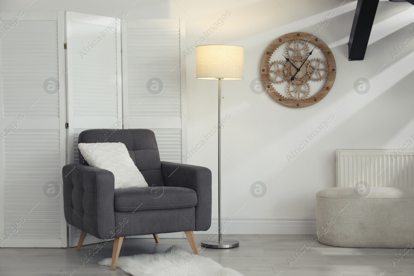 Photo of Living room interior with stylish lamp and comfortable armchair