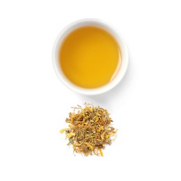 Freshly brewed tea and dry leaves on white background, top view