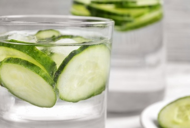 Photo of Glass with fresh cucumber water, closeup. Space for text