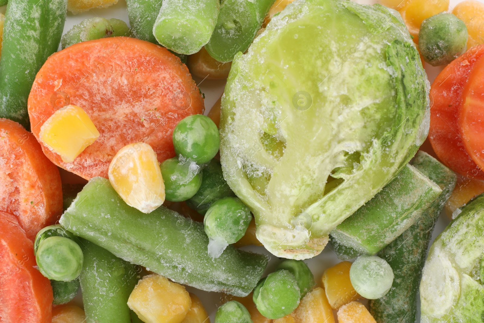 Photo of Mix of different frozen vegetables as background, top view