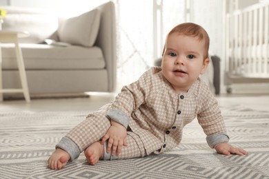 Photo of Portrait of cute baby on floor at home
