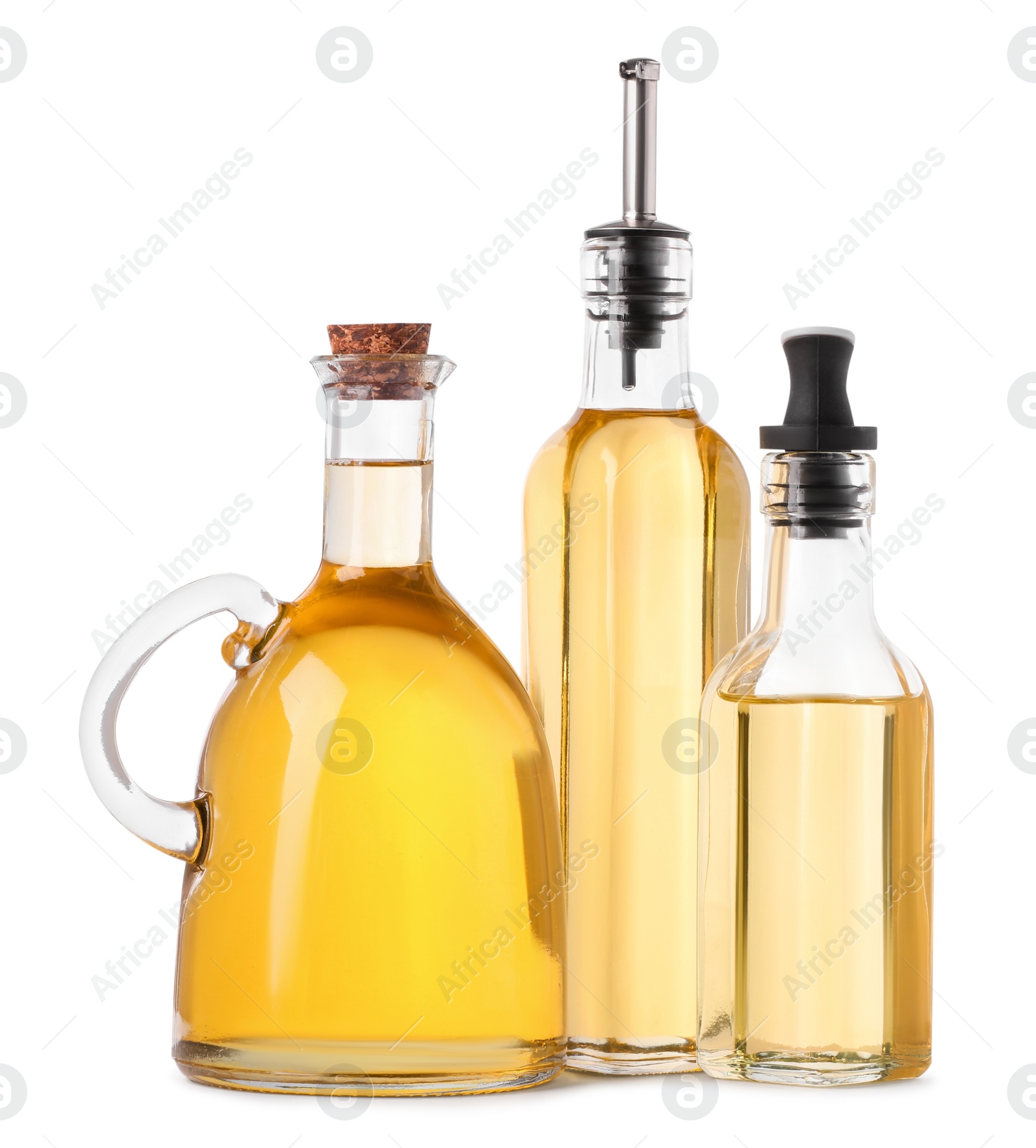 Photo of Different glass bottles of cooking oil on white background