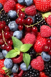 Photo of Many different fresh ripe berries as background, top view