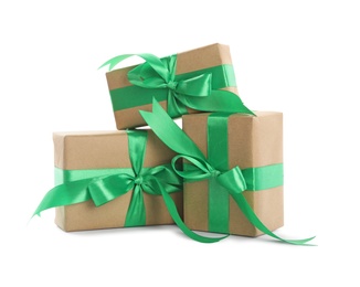 Christmas gift boxes decorated with green bows on white background