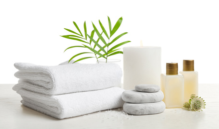 Photo of Composition with spa stones on white wooden table