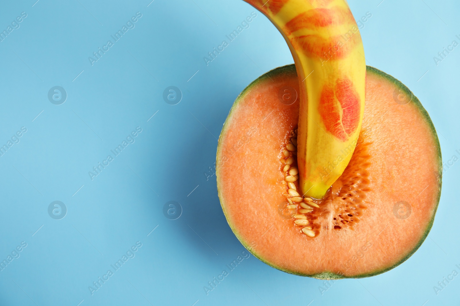 Photo of Flat lay composition with fresh banana and melon on blue background, space for text. Sex concept