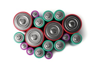 Photo of Many different new batteries isolated on white, top view