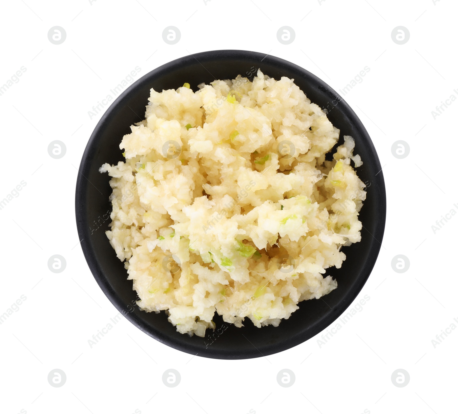 Photo of Chopped garlic in bowl isolated on white, top view