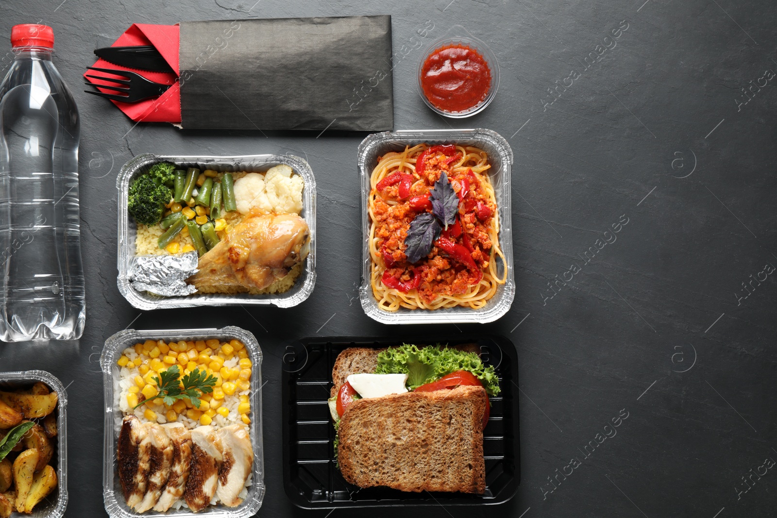 Photo of Lunchboxes on grey table, flat lay. Healthy food delivery