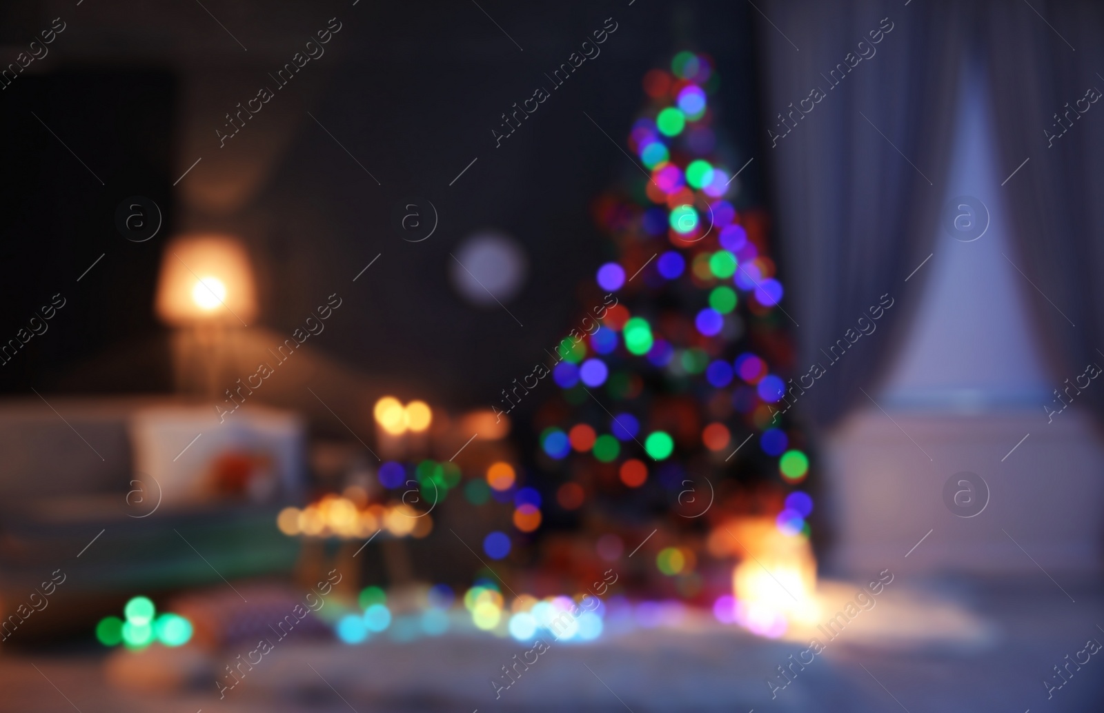 Photo of Blurred view of stylish room interior with decorated Christmas tree