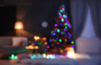 Photo of Blurred view of stylish room interior with decorated Christmas tree