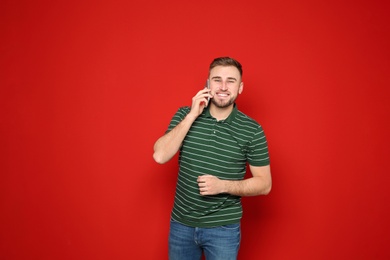 Portrait of man talking on phone against color background. Space for text