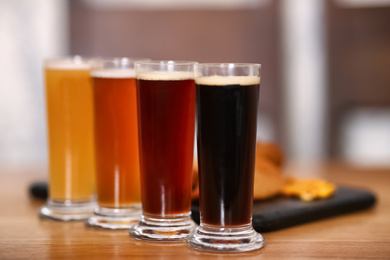 Photo of Beer tasting set served on wooden table