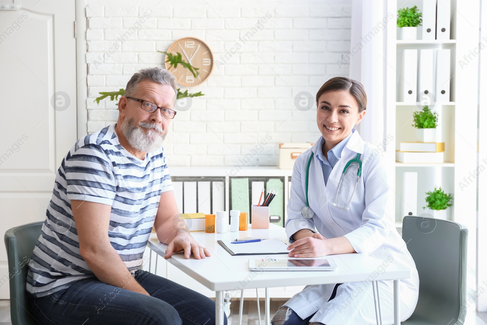 Photo of Female doctor consulting patient in clinic