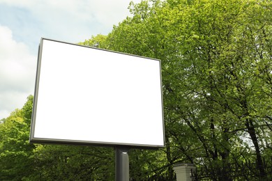 Photo of Blank advertising board in city. Mockup for design