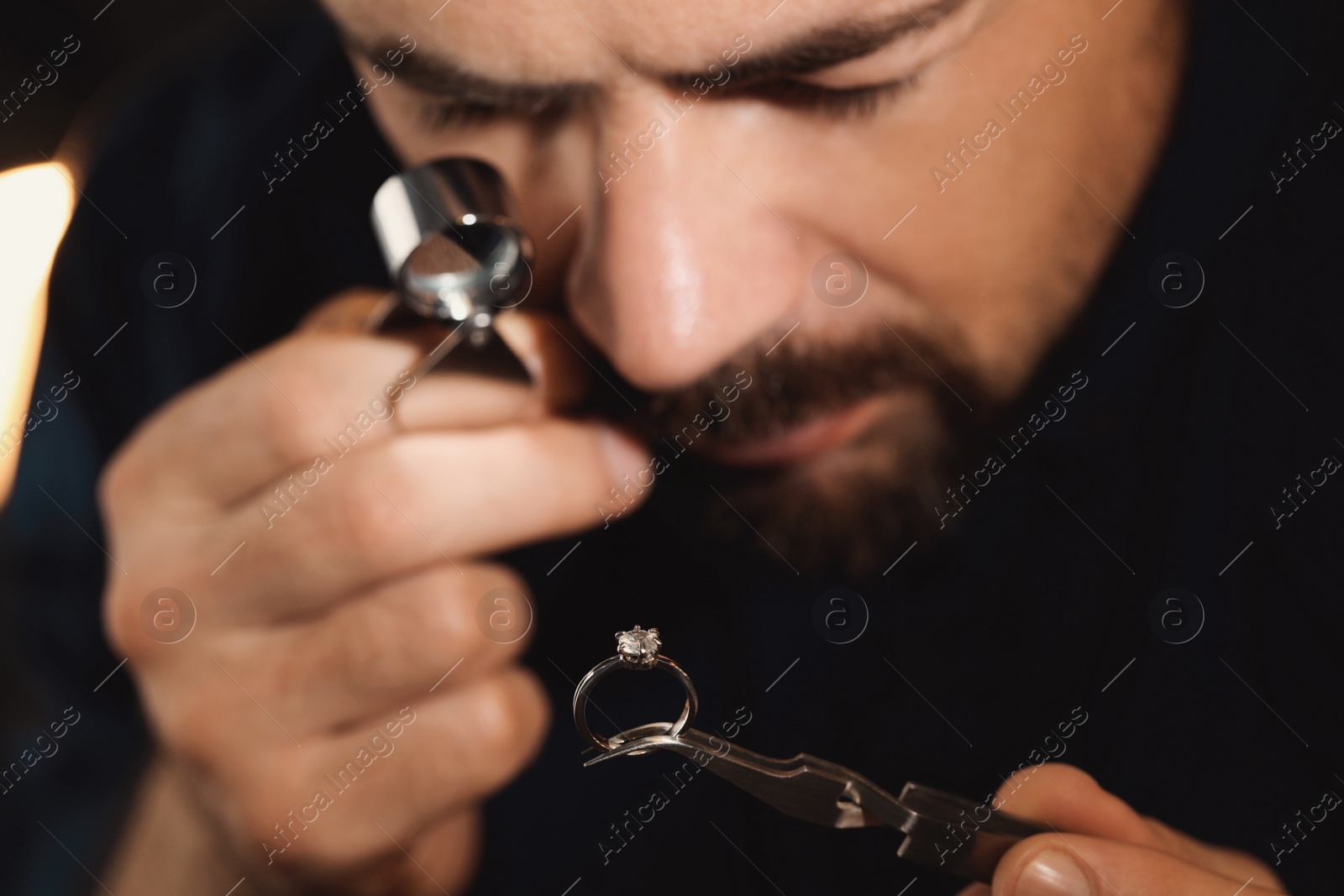 Photo of Professional jeweler working with ring, closeup view