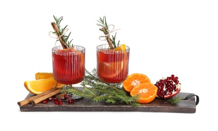 Photo of Christmas Sangria cocktail in glasses, ingredients and fir tree branches isolated on white