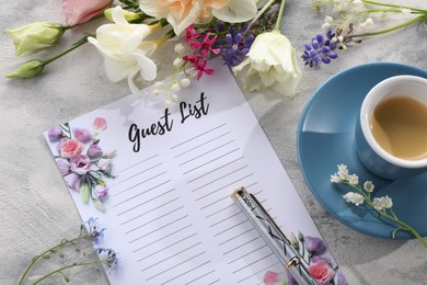 Photo of Guest list, coffee, pen and beautiful flowers on light textured table. Space for text