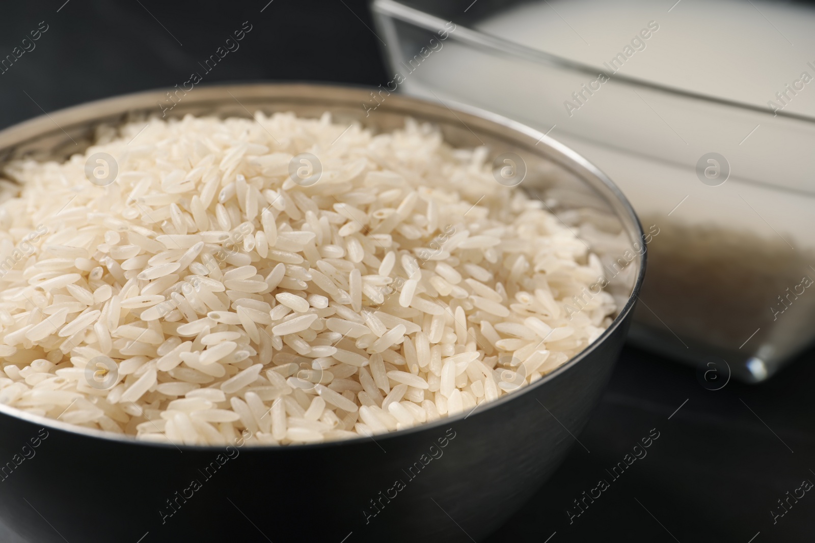 Photo of Grains and rice water on black table, closeup