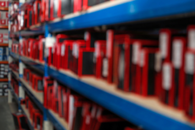 Blurred view of shelving unit with merchandise in modern wholesale shop