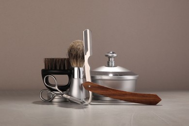 Photo of Moustache and beard styling tools on grey table