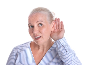 Mature woman with hearing problem on white background