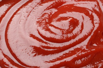 Photo of Tasty ketchup as background, closeup. Tomato sauce