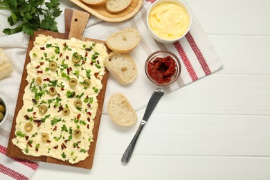 Photo of Fresh natural butter board with sun-dried tomatoes, bread and knife on white wooden table, flat lay. Space for text