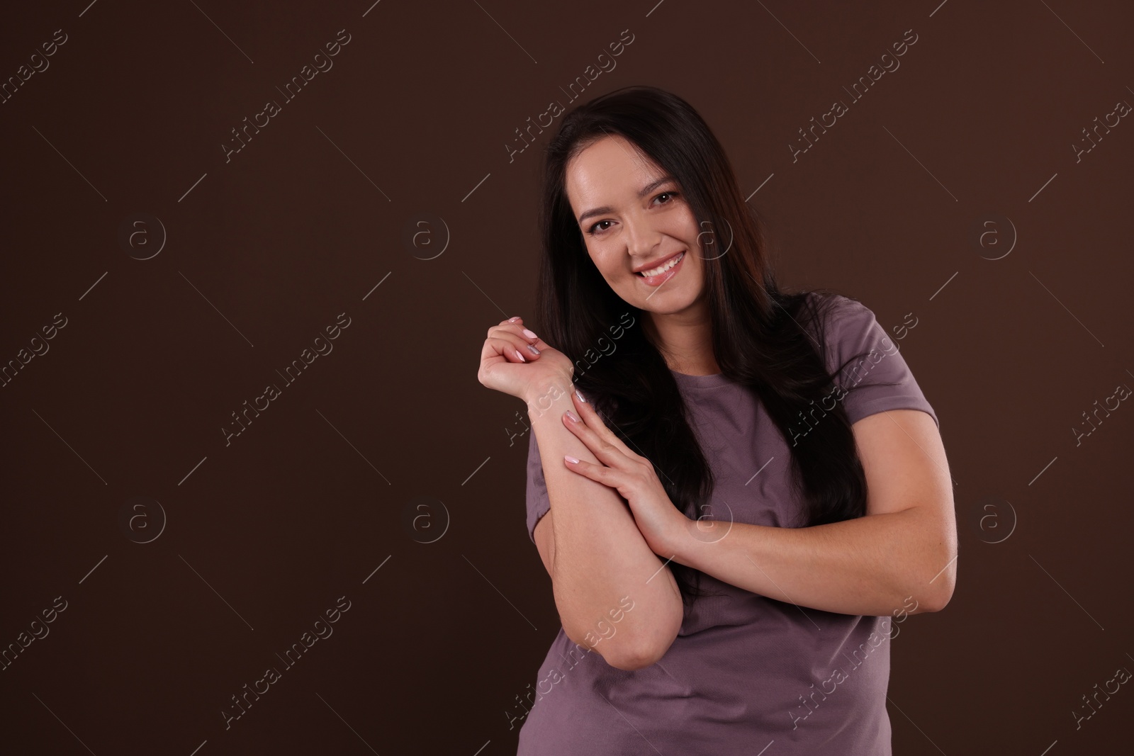 Photo of Beautiful overweight woman with charming smile on brown background. Space for text