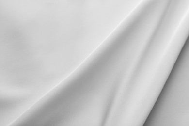 Photo of Texture of white silk ripple fabric as background, top view