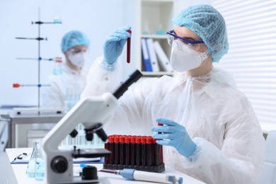 Scientist working with samples in test tubes in laboratory